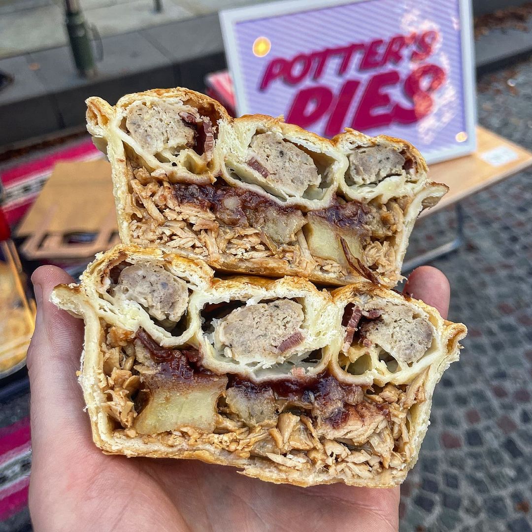 A Christmas dinner pie with a pigs in blanket sausage roll crust has